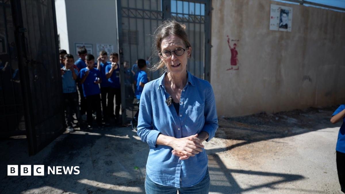 Pupils return to West Bank school behind barbed wire to protect against settlers